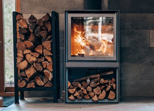 fireplace with glass covering and firewood